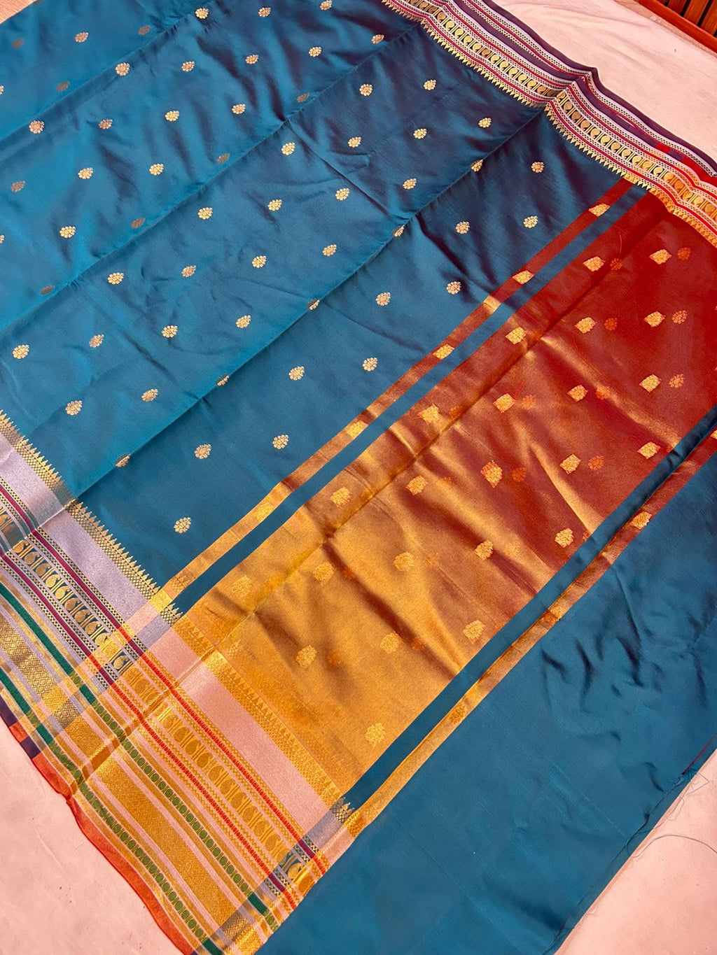 Royal Peacock Blue Banarasi Katan Silk Saree with Rich Zari Buti & Contrast Copper Gold Pall