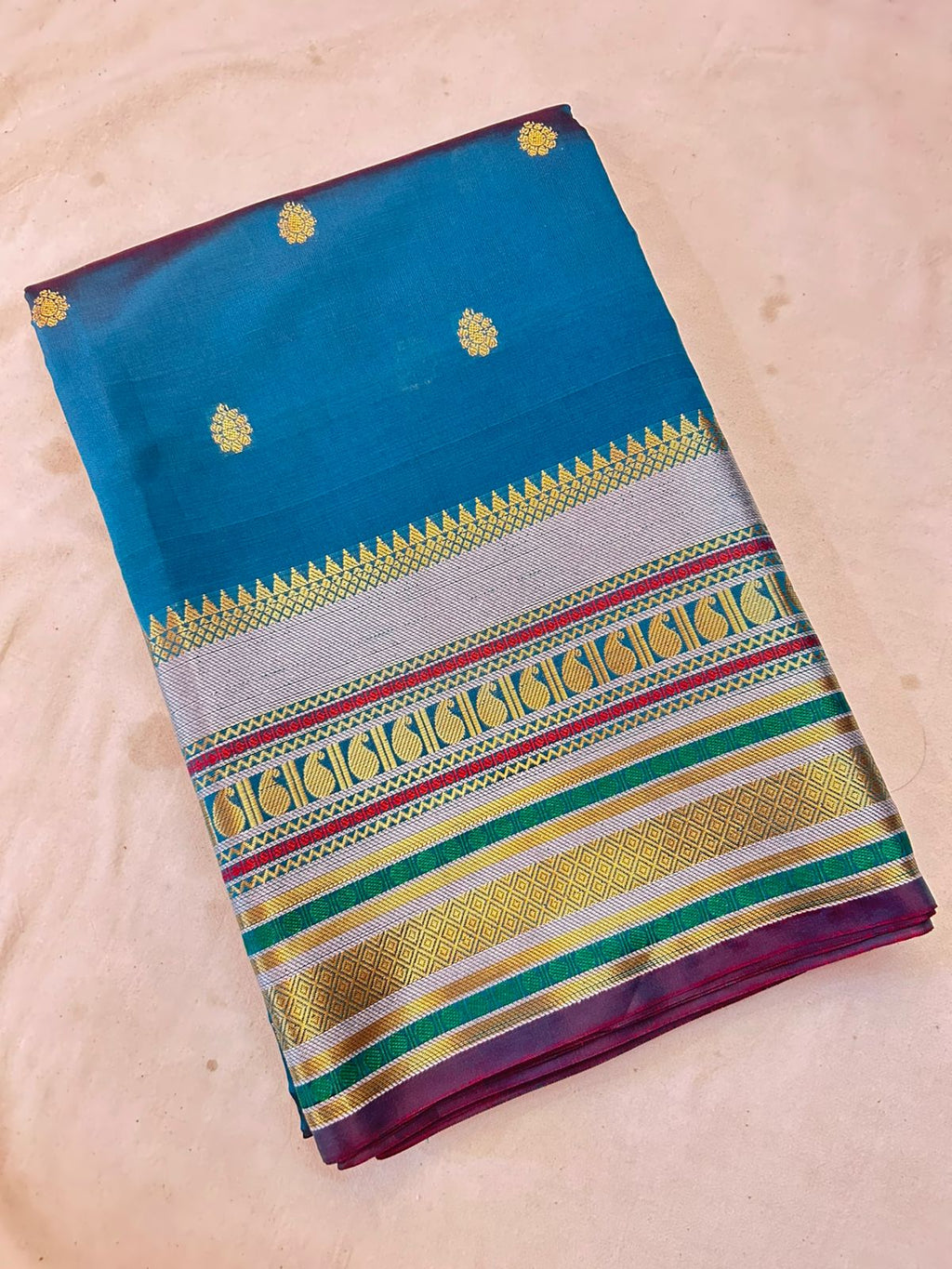 Royal Peacock Blue Banarasi Katan Silk Saree with Rich Zari Buti & Contrast Copper Gold Pall